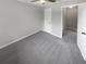 Well-lit bedroom with grey carpet and access to hallway at 3541 Old Chamblee Tucker Rd # G, Atlanta, GA 30340