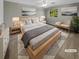 Virtually staged main bedroom with king-size bed and seating area at 3541 Old Chamblee Tucker Rd # G, Atlanta, GA 30340