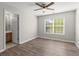 Bedroom with ceiling fan, hardwood floors, and adjacent bathroom at 911 Queensbrooke Way, Mableton, GA 30126