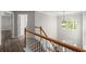 Upstairs hallway with hardwood floors and a view of the entryway at 911 Queensbrooke Way, Mableton, GA 30126