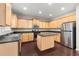 Modern kitchen with island, stainless steel appliances, and light wood cabinets at 911 Queensbrooke Way, Mableton, GA 30126