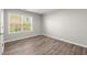 Bright bedroom with hardwood floors and large window at 911 Queensbrooke Way, Mableton, GA 30126