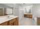 Main bathroom with double vanity and large mirror at 911 Queensbrooke Way, Mableton, GA 30126