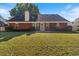 Large backyard with grassy area and brick house at 3540 Rivers End Pl, Buford, GA 30519