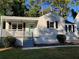 Charming ranch home with light-colored brick, black shutters, and a covered porch at 411 Greencove Se Ln, Atlanta, GA 30316