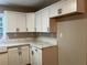 Modern kitchen with white cabinets and quartz countertops at 411 Greencove Se Ln, Atlanta, GA 30316