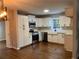 Modern kitchen with white shaker cabinets, quartz countertops, stainless steel appliances, and hardwood floors at 411 Greencove Se Ln, Atlanta, GA 30316