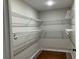 Large walk-in closet with wire shelving and hanging rods at 411 Greencove Se Ln, Atlanta, GA 30316
