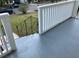 Front porch with gray flooring, white railing, and black metal stairs at 411 Greencove Se Ln, Atlanta, GA 30316