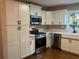 Bright kitchen with stainless steel appliances and white cabinets at 411 Greencove Se Ln, Atlanta, GA 30316