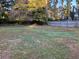 Backyard with lush trees, grass, and a fence at 411 Greencove Se Ln, Atlanta, GA 30316