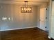 Formal dining area with hardwood floors, a modern light fixture, and neutral wall tones at 411 Greencove Se Ln, Atlanta, GA 30316