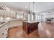 Open concept kitchen with large island, hardwood floors, and white cabinets at 2423 Rosapenna Nw Ln, Kennesaw, GA 30152