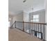 Upstairs hallway with chandelier, and iron railing overlooking entry at 2423 Rosapenna Nw Ln, Kennesaw, GA 30152
