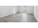 Bedroom with grey wood-look floors and large window at 5560 Kingsport Dr # 27, Atlanta, GA 30342