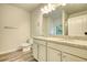 Double vanity bathroom with granite countertop, and grey plank flooring at 960 Park Place St, Social Circle, GA 30025