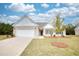 Ranch style home with a two-car garage and front yard at 960 Park Place St, Social Circle, GA 30025