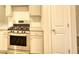 Modern kitchen featuring stainless steel gas range and granite countertops at 960 Park Place St, Social Circle, GA 30025