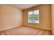 Bright bedroom with neutral carpeting and window overlooking the street at 960 Park Place St, Social Circle, GA 30025