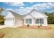 Brick ranch house with attached garage, landscaping, and spacious yard at 960 Park Place St, Social Circle, GA 30025