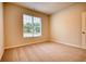 Bright bedroom featuring a large window and carpet flooring at 960 Park Place St, Social Circle, GA 30025