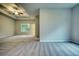 Main bedroom with tray ceiling and carpet flooring at 960 Park Place St, Social Circle, GA 30025