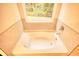 Bathroom with garden tub and tile surround at 960 Park Place St, Social Circle, GA 30025