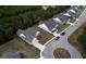 Aerial view of charming homes with grey roofs and brick exteriors, showcasing a peaceful community setting at 960 Park Place St, Social Circle, GA 30025
