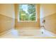 Bathroom with garden tub and tile surround at 960 Park Place St, Social Circle, GA 30025