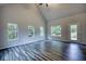Bright living room featuring hardwood floors, vaulted ceilings, and multiple windows at 960 Park Place St, Social Circle, GA 30025