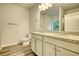 Double vanity bathroom with granite countertop, and grey plank flooring at 960 Park Place St, Social Circle, GA 30025
