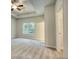 Main bedroom with window, ceiling fan and carpet at 960 Park Place St, Social Circle, GA 30025