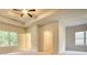 Main bedroom with tray ceiling, walk-in closet and carpet at 960 Park Place St, Social Circle, GA 30025