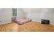 Upstairs bedroom with laminate flooring and a window at 4012 Union Church Sw Rd, Stockbridge, GA 30281