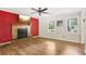 Living room with a fireplace, hardwood floors, and large windows at 4012 Union Church Sw Rd, Stockbridge, GA 30281