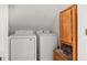 Laundry room with washer, dryer, and wooden cabinet at 4012 Union Church Sw Rd, Stockbridge, GA 30281