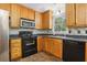 Kitchen with wood cabinets, stainless steel appliances, and tile floors at 4012 Union Church Sw Rd, Stockbridge, GA 30281