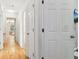 Hallway with light wood floors and access to bedrooms at 4012 Union Church Sw Rd, Stockbridge, GA 30281