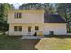 Rear view of house, showcasing white siding and patio at 4012 Union Church Sw Rd, Stockbridge, GA 30281