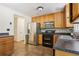 Kitchen with wood cabinets, stainless steel appliances, and tile floors at 4012 Union Church Sw Rd, Stockbridge, GA 30281