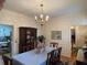 Formal dining room with a chandelier and floral wallpaper at 220 Spalding Lake Pl, Atlanta, GA 30350