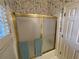Clean bathroom with a shower/tub combo and gold accents at 220 Spalding Lake Pl, Atlanta, GA 30350