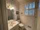 Charming bathroom with floral wallpaper and updated fixtures at 220 Spalding Lake Pl, Atlanta, GA 30350