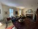 Cozy living room with a brick fireplace and hardwood floors at 220 Spalding Lake Pl, Atlanta, GA 30350