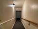 Basement stairs with carpeted steps and wooden railing at 220 Spalding Lake Pl, Atlanta, GA 30350