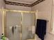 Bathroom with shower and gold-framed glass enclosure at 220 Spalding Lake Pl, Atlanta, GA 30350