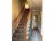 Elegant staircase with wooden railing and a chandelier at 220 Spalding Lake Pl, Atlanta, GA 30350