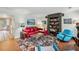 Living room with red sectional sofa, eclectic decor, and hardwood floors at 1053 Riverbend Club Se Dr, Atlanta, GA 30339