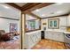 Open kitchen with white cabinets, stainless steel appliances, and a view into adjacent living area at 1053 Riverbend Club Se Dr, Atlanta, GA 30339