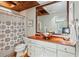 Bathroom with a shower/tub combo, wood vanity and terracotta floor at 1053 Riverbend Club Se Dr, Atlanta, GA 30339